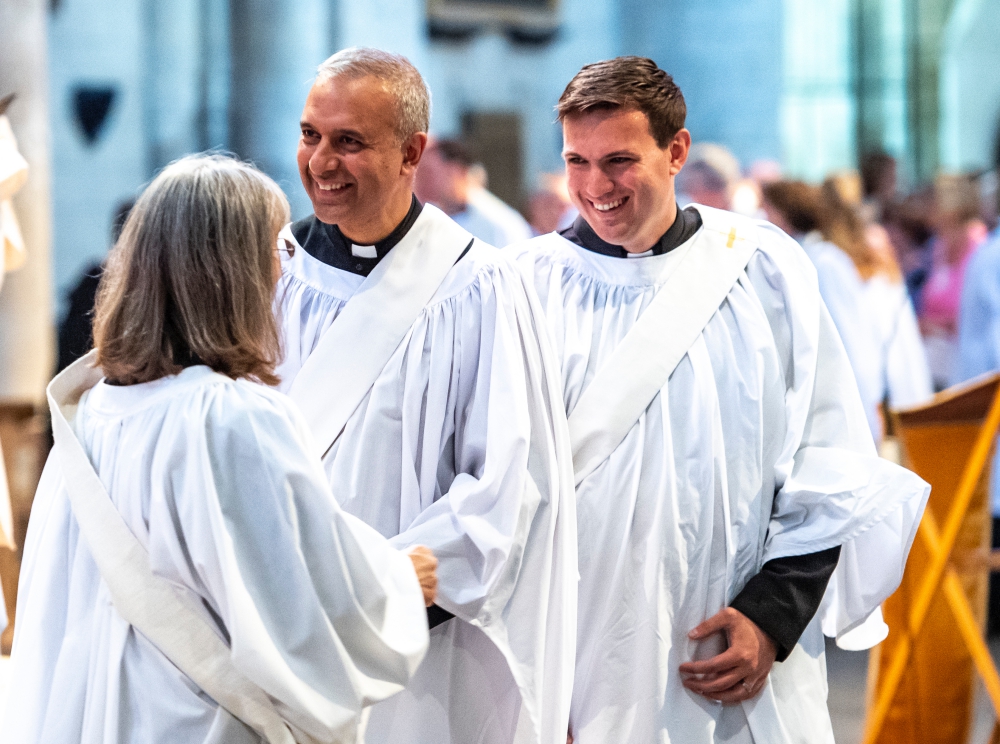 Two smiling male clergy at an ordination service